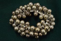 A silver ball bracelet.