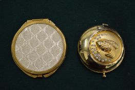 Two Estee Lauder powder puffs.