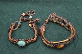 A bracelet set with a tigers eye and other items.