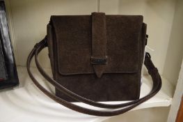 A Chanel brown suede bag.