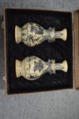 A boxed pair of Chinese blue and white vases.