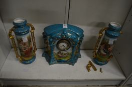 A porcelain clock garniture (one vase af).