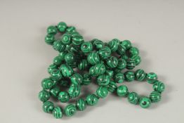 A STRING OF MALACHITE BEADS. 90cms.