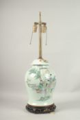 A CHINESE PORCELAIN TEMPLE VASE on a wooden base, as a lamp.