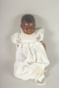 ARMAND MARSEILLE BISQUE HEADED BLACK BABY DOLL, No. 351, articulated body, clothed. 25cms high.
