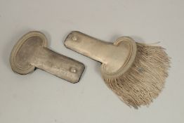 A PAIR OF SILVER EPAULETTES, REPUBLIC OFFICER in a box, lid missing. O.M.C. PARIS 1ST TITRE.