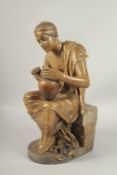 A GOLDSCHEIDER SIGNED POTTERY FIGURE OF A SEATED YOUNG ROMAN holding a pitcher. 50cms high.