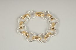 A HALLMARKED STERLING SILVER TWISTED CIRCULAR LINK BRACELET with gold plated links.
