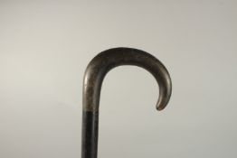 A WALKING STICK with a silver handle and another with silver band. Both 84cms long.