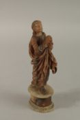 AN 18TH CENTURY, POSSIBLY GERMAN, CARVED ALABASTER FIGURE OF A SAINT praying on an oval stand. 21cms