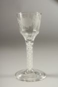 A GEORGIAN WINE GLASS, the bowl engraved with roses, with air twist stem. 15cms high, three tiny