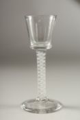 A GEORGIAN WINE GLASS with plain bowl and white air twist stem. 15cms high.