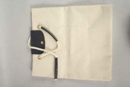 A LARGE LONGCHAMP CREAM FABRIC BAG. 45cms long x 40cms deep.