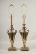 A PAIR OF BRASS TWO-HANDLED URN SHAPED LAMPS. 60cms high.