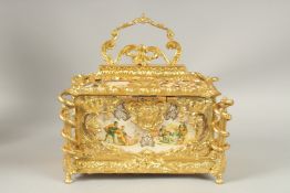 A LARGE GILT BRONZE CASKET with porcelain panels with velvet interior. 30cms high x 20cms wide.
