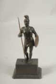 A 19TH CENTURY SPELTER FIGURE OF A CENTURION on rectangular base. 22cms high.