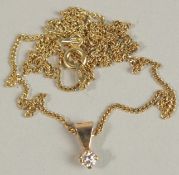 A 9CT YELLOW GOLD SOLITAIRE DIAMOND PENDANT on a gold-plated silver chain, boxed. RBC diamond 0.15ct