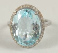 A SILVER BLUE TOPAZ AND DIAMOND RING.