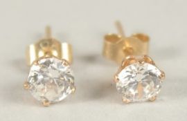 A PAIR OF SINGLE STONE DIAMOND STUD EARRINGS.