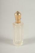 A GOLD TOP CUT GLASS SCENT BOTTLE. 8cms long.