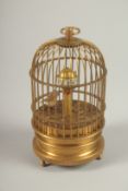 A SMALL GILT METAL BIRD in a cage clock. 13cms high.