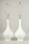 A PAIR OF 1920'S-1930'S WHITE GLASS BULBOUS LAMPS with chrome fittings. 50cms high.