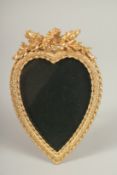 A GILT HEART SHAPED PHOTOGRAPH FRAME. 18cms high x 12cms wide.