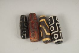 FOUR AGATE DZI BEADS.