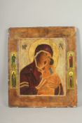 A LARGE RUSSIAN ICON, Madonna and Child, four saints to the border. 50cms x 44cms.