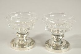 A PAIR OF CHRISTOFLE GLASS SALTS.