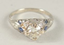 A PLATINUM DECO DIAMOND SINGLE STONE RING with sapphire shoulders.