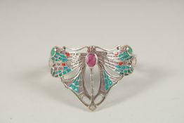 A SILVER RUBY, EMERALD AND SAPPHIRE DRAGONFLY BANGLE.