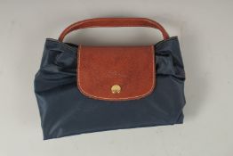 A LONGCHAMP BLUE FABRIC FOLDING BAG. 23cms x 12cms closed.