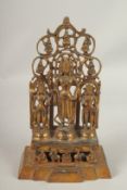 A TIBETAN GILT BRONZE SHRINE with three figures. 28cms high.