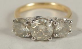 A CERTIFICATED 18CT YELLOW AND WHITE GOLD RBC DIAMOND TRILOGY RING. Diamonds 3.67ct. Cert. No.