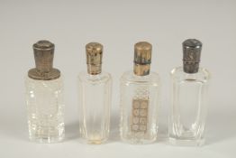 FOUR SILVER TOP SCENT BOTTLES.