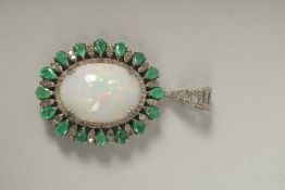 A SILVER AND GOLD OPAL, EMERALD AND DIAMOND PENDANT.