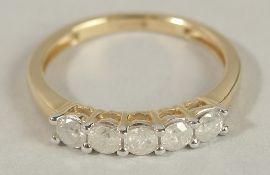A 9CT YELLOW GOLD FIVE-STONE LINEAR-SET RBC DIAMOND RING. Diamonds 0.50ct.