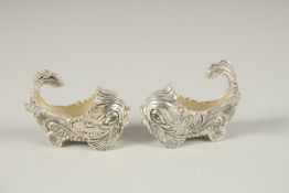 A PAIR OF PLATE DOLPHIN SALTS AND SPOONS.