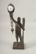 AN AIRMAN BRONZED SWING CLOCK. 34cms high