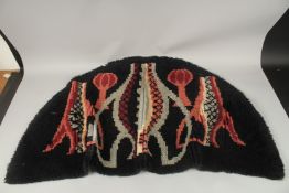 A WOOLLEN HEARTH RUG. 124cms x 66cms.