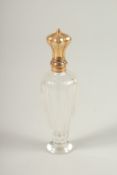 A GOLD TOP GLASS SCENT BOTTLE. 10cms long.