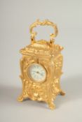 A MINI CAST METAL ORNATE CARRIAGE CLOCK. 7cms high.