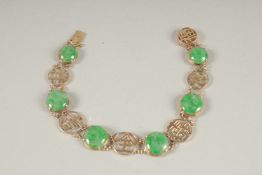 A 14CT GOLD CHINESE DESIGN JADE BRACELET.