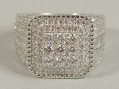 A SQUARE CHECKERBOARD-STYLE SILVER GENT'S RING set with round and baguette white cubic zirconia.