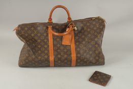 AN UNUSED LOUIS VUITTON LEATHER HOLDALL and A LOUIS VUITTON WALLET.