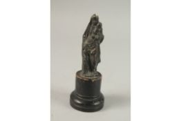 AN EARLY BRONZE MADONNA AND CHILD on a wooden base. 12cms high.