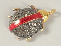 A GOLD AND ENAMEL BEETLE CHARM.