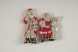 TWO SILVER ENAMEL FATHER CHRISTMAS BROOCHES.