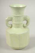 A CHINESE CELADON TWIN-HANDLE CRACKLE GLAZE VASE. 24cms high.